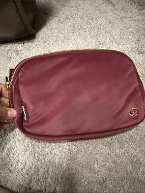 lululemon athletica wine red cosmetic pouch with gold zipper